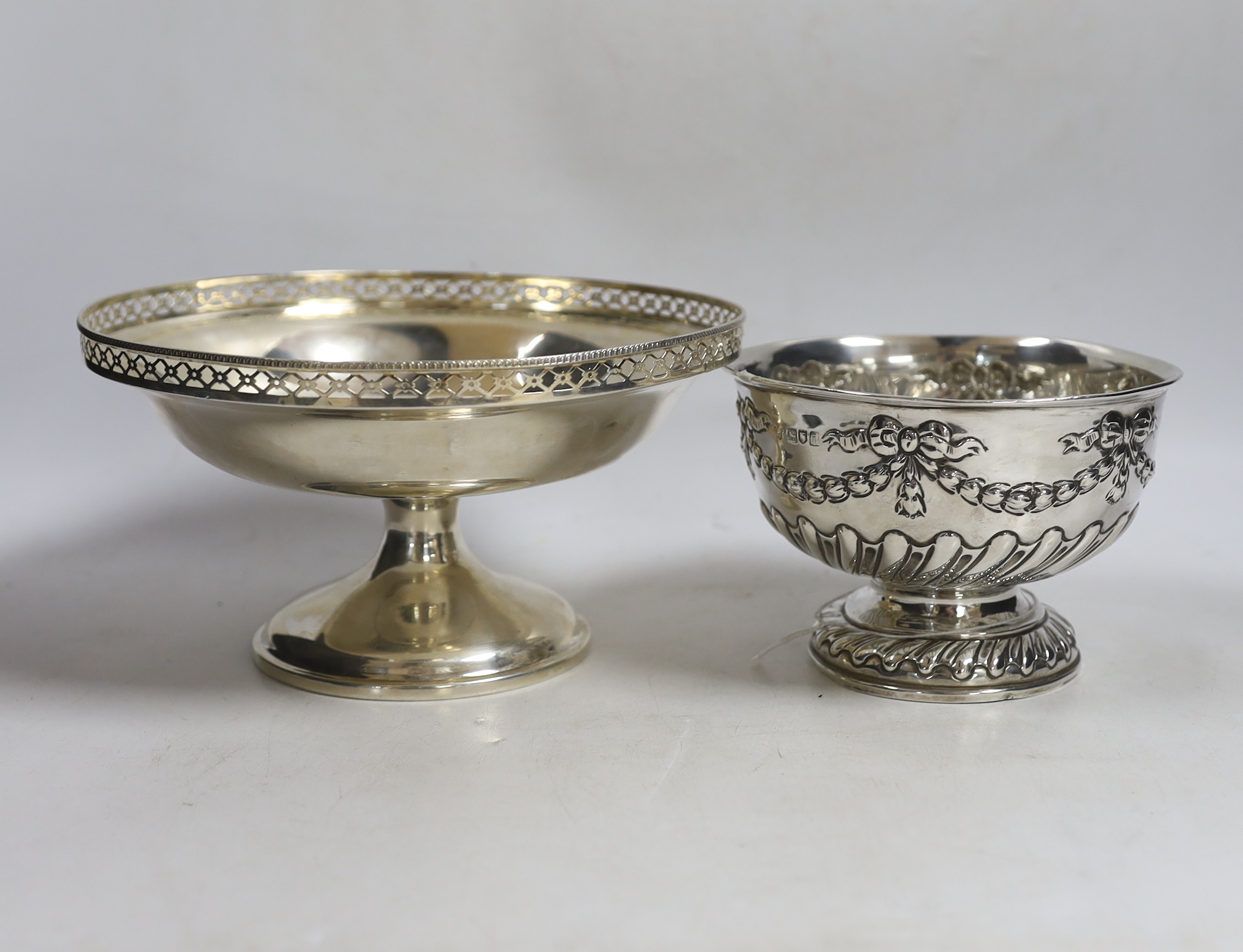 An Edwardian small repousse silver rose bowl, Charles Stuart Harris & Sons London, 1904, diameter 13.7cm and a later larger silver pedestal bowl, 15.3oz.